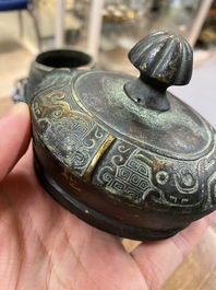 A Chinese archaic bronze ritual 'you' wine vessel and cover in Western Zhou-style, Ming