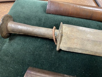 A Chinese bronze dagger with wooden scabbard in a display case, Han