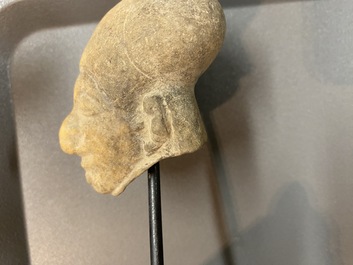 Acht diverse gesculpteerde stenen hoofden, o.a. Gandhara, Etruskisch, Japans en Chinees