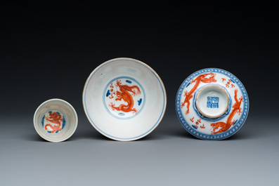 A Chinese blue, white and iron-red 'dragon' bowl and cover and a wine cup, Qianlong mark, 18/19th C.