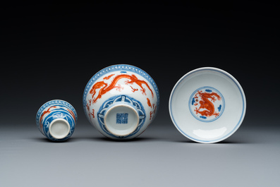 A Chinese blue, white and iron-red 'dragon' bowl and cover and a wine cup, Qianlong mark, 18/19th C.
