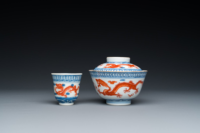 A Chinese blue, white and iron-red 'dragon' bowl and cover and a wine cup, Qianlong mark, 18/19th C.