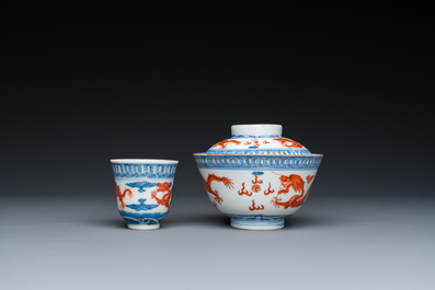 A Chinese blue, white and iron-red 'dragon' bowl and cover and a wine cup, Qianlong mark, 18/19th C.