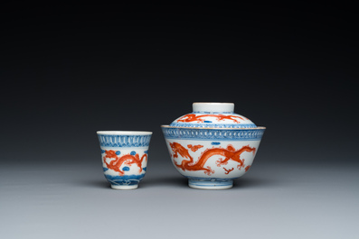 A Chinese blue, white and iron-red 'dragon' bowl and cover and a wine cup, Qianlong mark, 18/19th C.