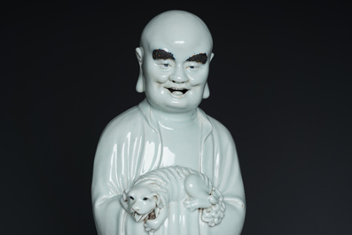 Two exceptionally tall Chinese white-glazed sculptures of Luohan, Qianlong/Jiaqing