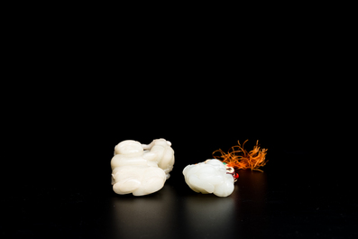 Two Chinese white and celadon jade carved standing boys, Qing