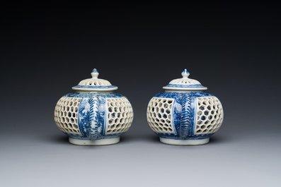 A pair of Chinese reticulated and double-walled blue and white teapots, Transitional period