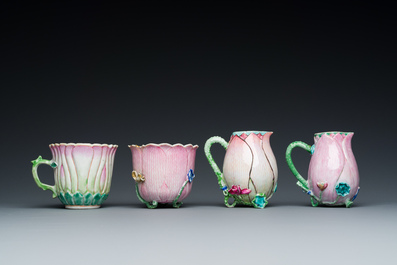 Two Chinese relief-decorated famille rose 'lotus' cups and saucers and two jugs, Yongzheng