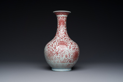 A Chinese copper-red bottle vase with floral scrolls, Qianlong