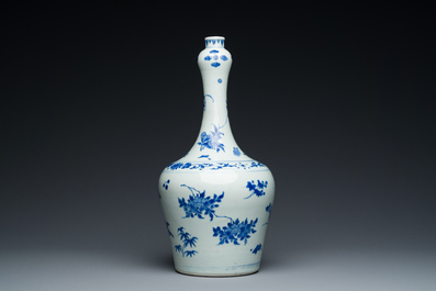 A Chinese blue and white bottle vase with floral designs, Transitional period