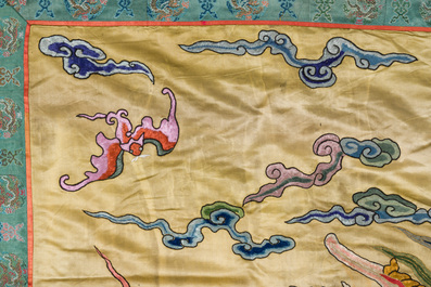 A large Chinese yellow-ground silk embroidery decorated with three five-clawed dragons, 19th C.