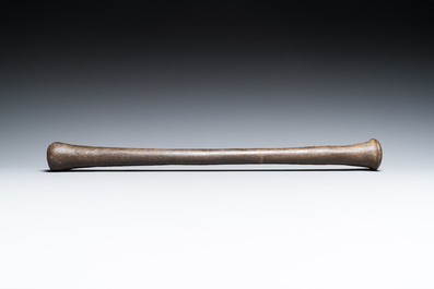 A large French bronze mortar and pestle on its carved oak base, dated 1631