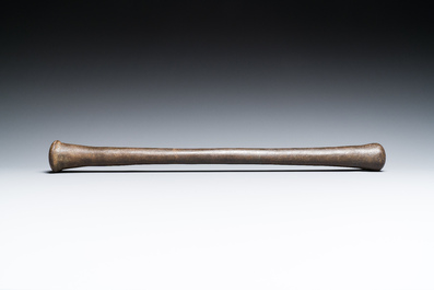 A large French bronze mortar and pestle on its carved oak base, dated 1631