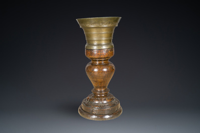 A large French bronze mortar and pestle on its carved oak base, dated 1631
