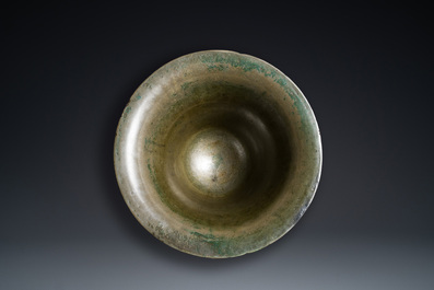 A large French bronze mortar and pestle on its carved oak base, dated 1631