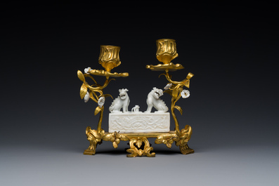 A Chinese Dehua blanc de Chine joss stick holder with French gilt bronze candlestick mounts, Kangxi and 18/19th C.