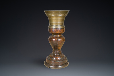 A large French bronze mortar and pestle on its carved oak base, dated 1631