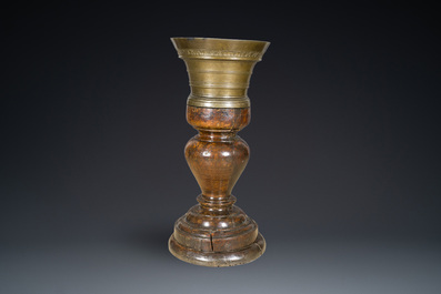 A large French bronze mortar and pestle on its carved oak base, dated 1631