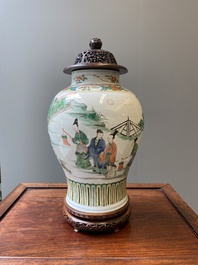 A Chinese famille verte vase with reticulated wooden cover and stand, Kangxi