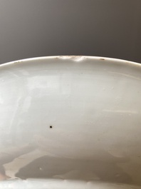 A Chinese famille verte dish with a lady in a garden and a boy offering her a 'jue' vessel, Kangxi