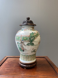 A Chinese famille verte vase with reticulated wooden cover and stand, Kangxi