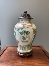 A Chinese famille verte vase with reticulated wooden cover and stand, Kangxi