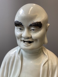 Two exceptionally tall Chinese white-glazed sculptures of Luohan, Qianlong/Jiaqing