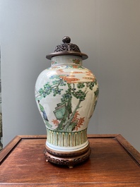 A Chinese famille verte vase with reticulated wooden cover and stand, Kangxi