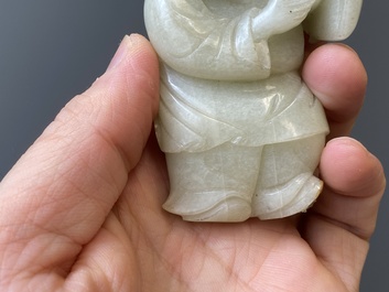 Two Chinese white and celadon jade carved standing boys, Qing