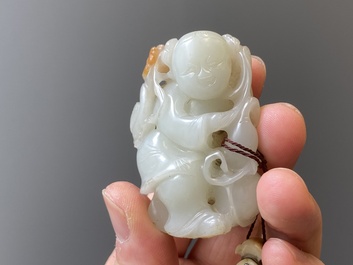 Two Chinese white and celadon jade carved standing boys, Qing