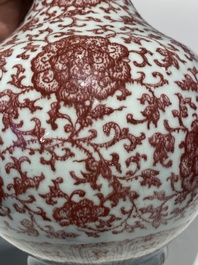 A Chinese copper-red bottle vase with floral scrolls, Qianlong