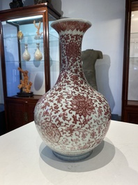 A Chinese copper-red bottle vase with floral scrolls, Qianlong