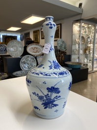A Chinese blue and white bottle vase with floral designs, Transitional period