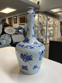 A Chinese blue and white bottle vase with floral designs, Transitional period
