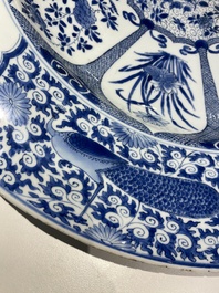 An exceptionally large Chinese blue and white 'peacock rim' dish, Kangxi
