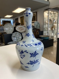 A Chinese blue and white bottle vase with floral designs, Transitional period