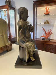 A Chinese lacquered and polychromed wood sculpture of a Buddhist guardian, Ming