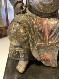 A Chinese lacquered and polychromed wood sculpture of a Buddhist guardian, Ming
