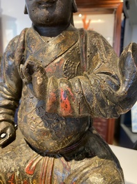 A Chinese lacquered and polychromed wood sculpture of a Buddhist guardian, Ming