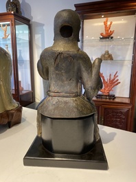 A Chinese lacquered and polychromed wood sculpture of a Buddhist guardian, Ming