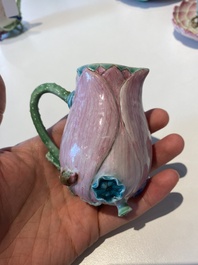 Two Chinese relief-decorated famille rose 'lotus' cups and saucers and two jugs, Yongzheng
