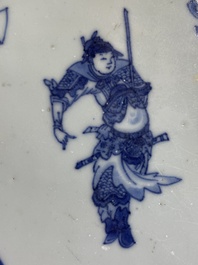 Deux carreaux en porcelaine de Chine en bleu et blanc &agrave; d&eacute;cor d'un lettr&eacute; et d'un gardien, &eacute;poque Transition