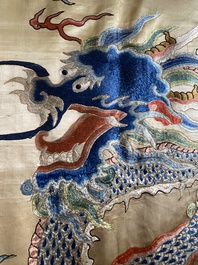 A large Chinese yellow-ground silk embroidery decorated with three five-clawed dragons, 19th C.