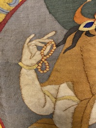 A Chinese kesi silk weaving depicting 'Buddha sitting on a lotus throne', Qing