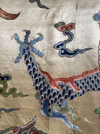 A large Chinese yellow-ground silk embroidery decorated with three five-clawed dragons, 19th C.