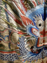 A large Chinese yellow-ground silk embroidery decorated with three five-clawed dragons, 19th C.