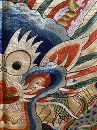 A large Chinese yellow-ground silk embroidery decorated with three five-clawed dragons, 19th C.