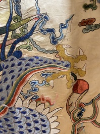 A large Chinese yellow-ground silk embroidery decorated with three five-clawed dragons, 19th C.