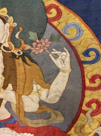 A Chinese kesi silk weaving depicting 'Buddha sitting on a lotus throne', Qing
