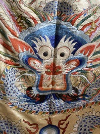 A large Chinese yellow-ground silk embroidery decorated with three five-clawed dragons, 19th C.